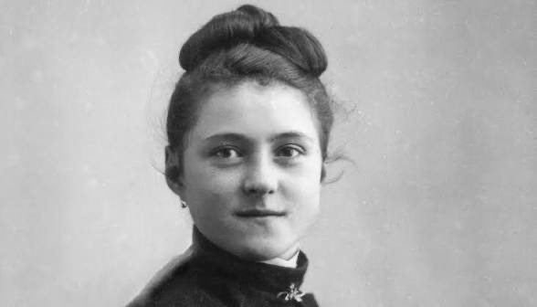 A young woman in a vintage portrait, showcasing styled hair in an elegant bun and wearing a dark, high-collared dress. The image evokes historical charm.